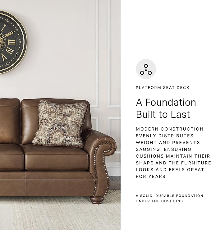 Signature Design by Ashley Shadsburne Rustic Faux Leather Sofa with Nailhead Trim and 2 Throw Pillows, Brown