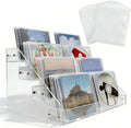 4-tier clear acrylic cascading CD holder, DVD/CD display stand, storage box, and vinyl record shelf. Holds up to 32 standard CD cases and includes 20 CD/DVD sleeves for organized media storage.