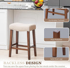 PrimeZone 26 Inch Solid Wood Saddle Backless Bar Stools Set of 2, Beige | Counter Height Barstools with Footrest & Nailhead Trim, Modern Farmhouse Upholstered Linen Counter Stools for Kitchen Island