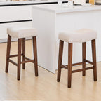 PrimeZone 26 Inch Solid Wood Saddle Backless Bar Stools Set of 2, Beige | Counter Height Barstools with Footrest & Nailhead Trim, Modern Farmhouse Upholstered Linen Counter Stools for Kitchen Island